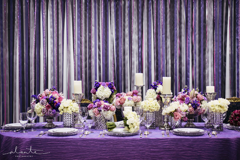 Purple and silver wedding decor with mercury glass and a ribbon background